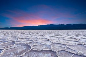 The sun sets on the salt crystal formations of Badwater Basin in Death Valley in this composite image.